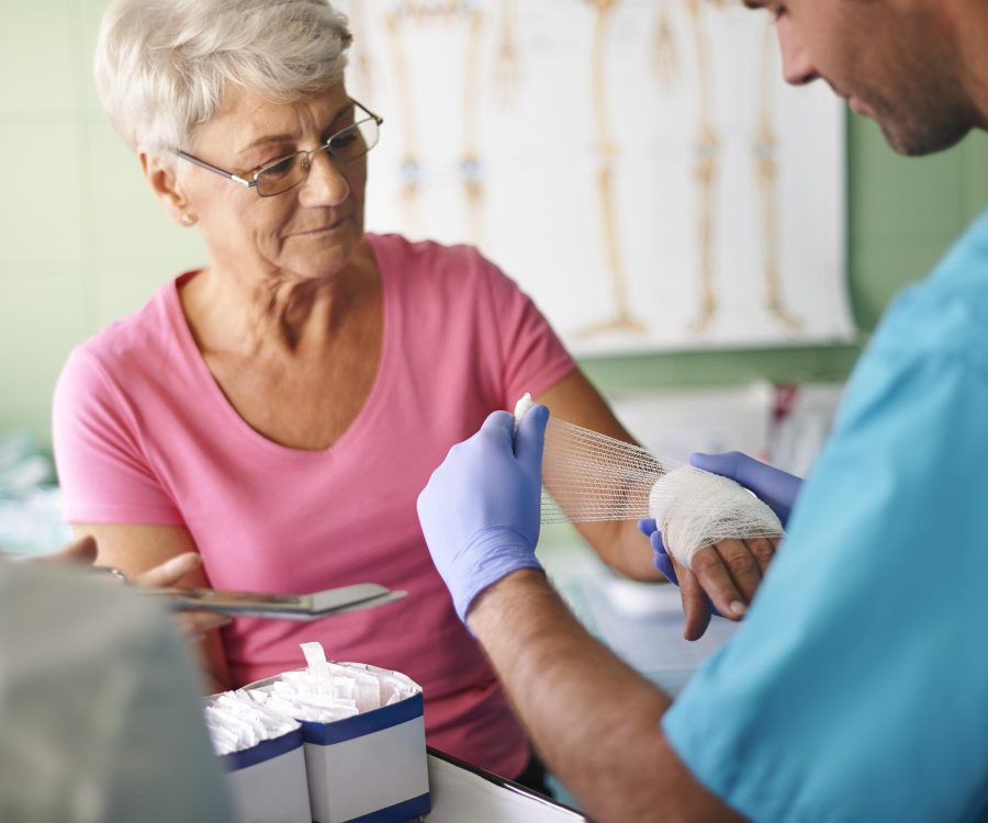 Senior woman with bandage on the hand Wound Care Specialists